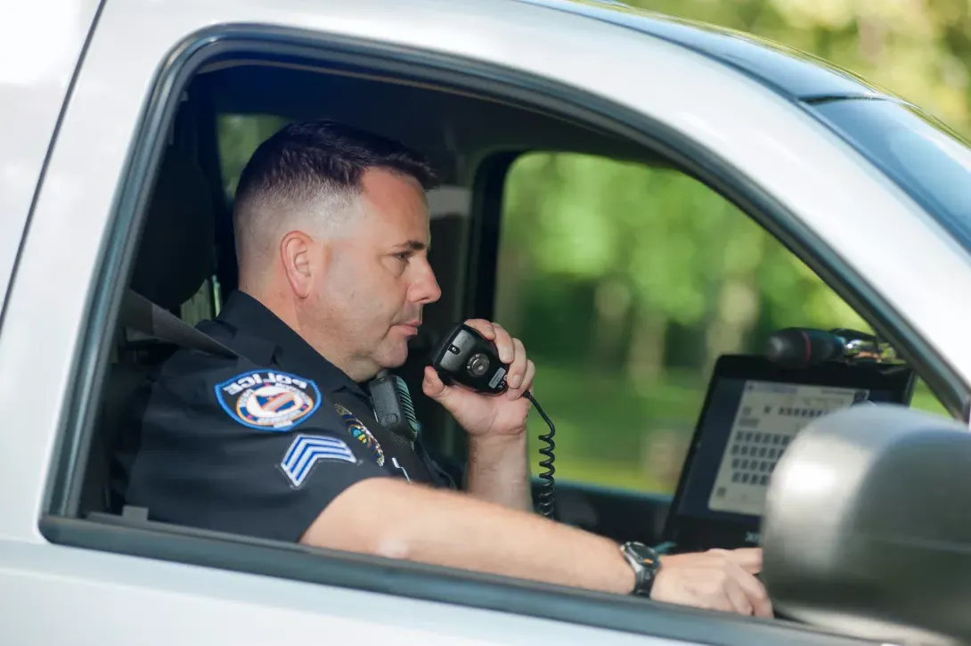 Police office sitting in car